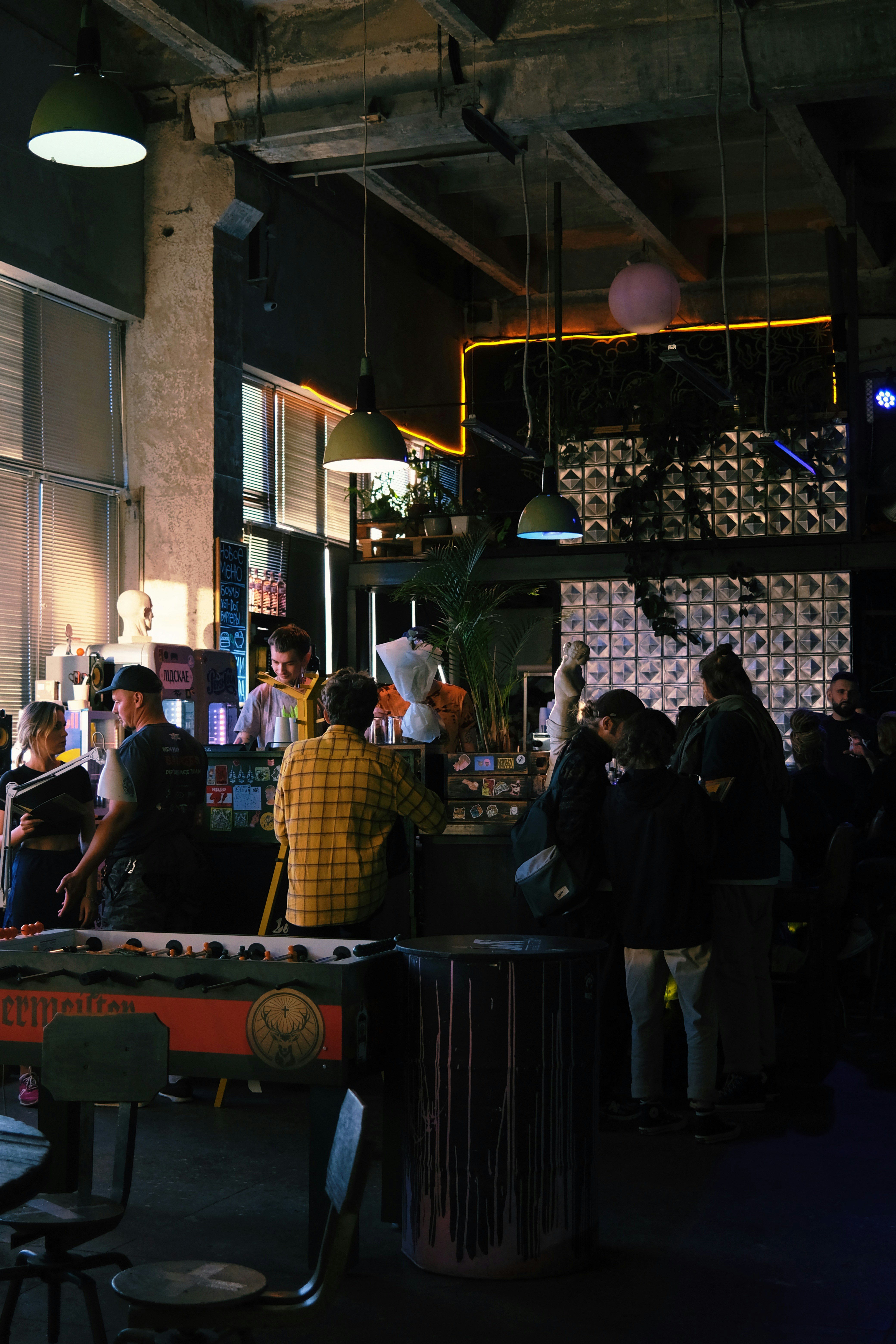 people standing near brown wooden table during daytime